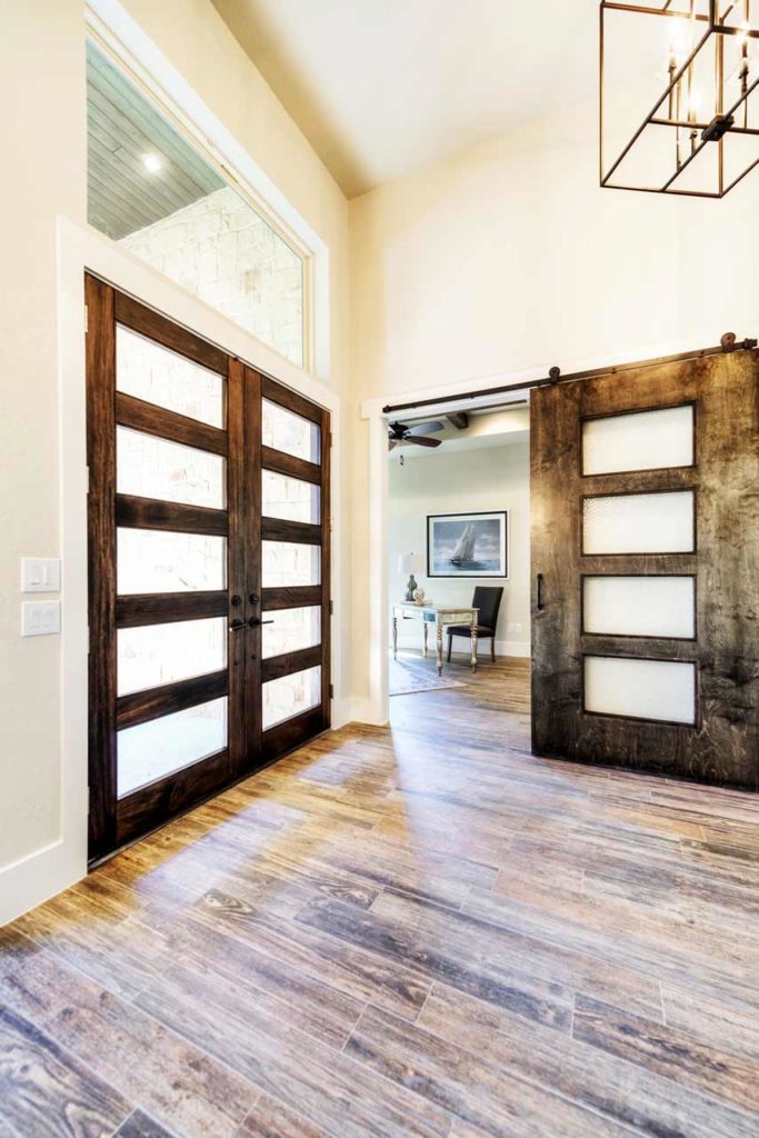 front door entry with hardwood floors and wood and glass doors
